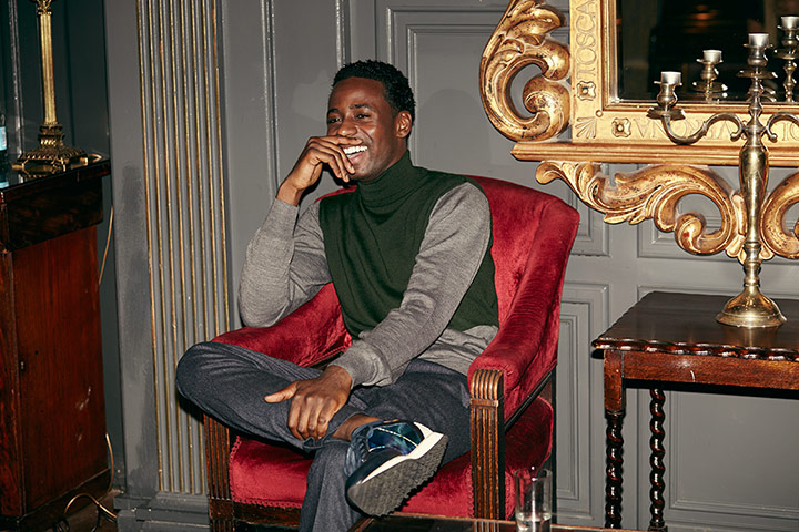 Downton Abbey - Weekend: Gary Carr from Downton Abbey sitting on red velvet chair