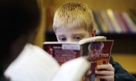 A child reading in the library at a primary school in the UK