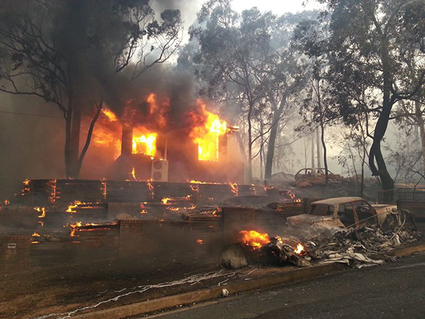 bushfire: A house is engulfed in flames