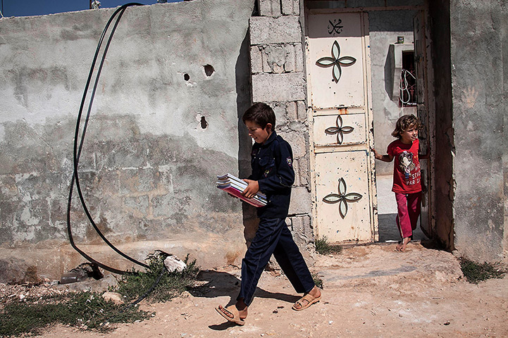 Syria schoolchildren: 12-year-old Abdo al-Fikri walks to school from his family home in Madaya vi