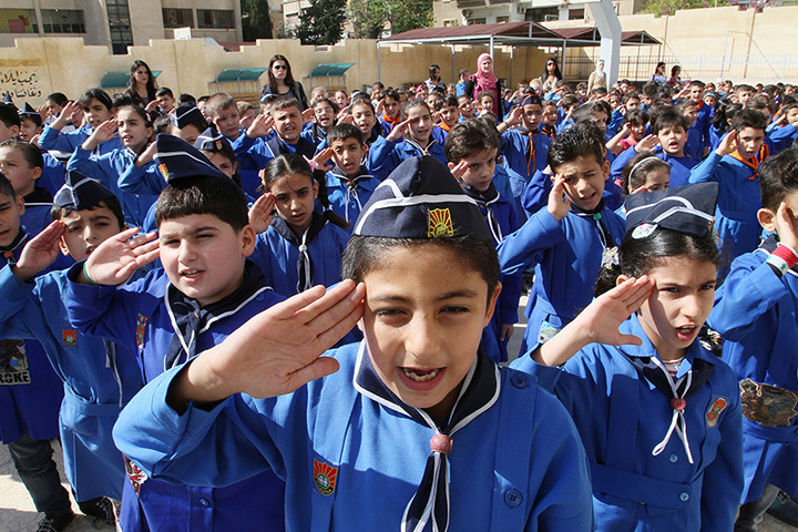 Syria schoolchildren: Syrian students salute while listening to the national anthem before enteri