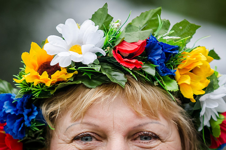 Weekend in pictures: London, England: A spectator wears a traditional flower wreath