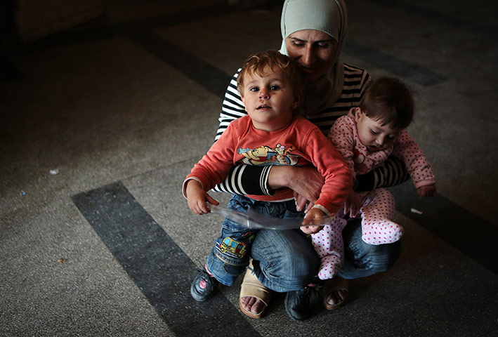 Weekend in pictures: Sofia, Bulgaria: A Syrian mother holds her children