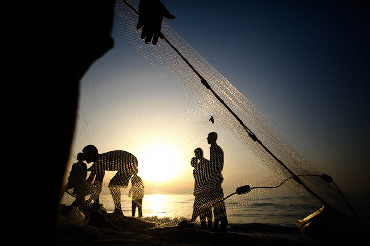 Weekend in pictures: Gaza Strip: A Palestinian refugee pulls his father's nets from the sea