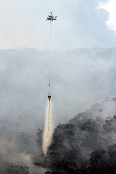 Bushfires monday: A water bomber dropping water