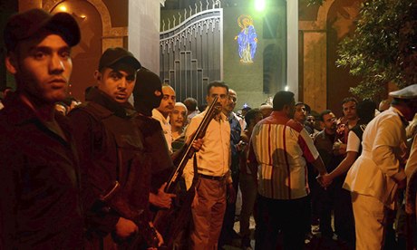 Egyptian security forces stand guard outside the Coptic Christian church attacked by gunmen
