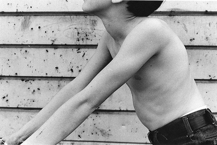 Mark Cohen: Bare thin arms against aluminum siding, 1981