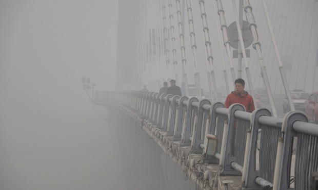 A pedestrian is picked out of the gloom in his red jacket on a smoggy day in Jilin in China. Concern is growing over air quality in Chinese cities as the density of airborne particles is several times above World Health Organisation recommended limits.