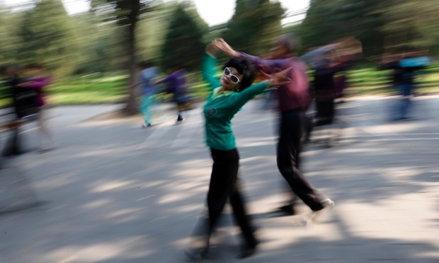 In a blur of movement people practice ballroom dancing during a morning exercise session at the Temple of Heaven park in Beijing.