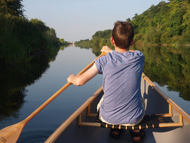 Your Pictures - Glide: boy in boat on river with paddle