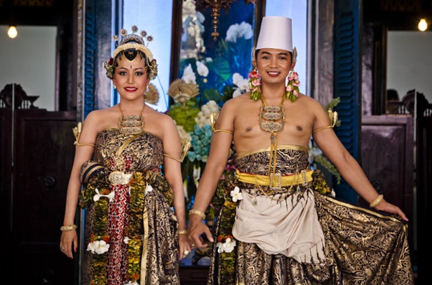 The happy couple posing for this portrait are the Sultan's daughter Gusti Kanjeng Ratu Hayu and her groom KPH Notonegoro photographed during their wedding ceremony in Bangsal Kesatriyan at Kraton Palace in Yogyakarta, Indonesia.