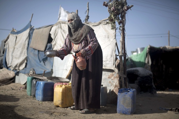 Here is a good example of a portrait with context. A Palestinian Bedouin woman washes a bowl at a camp where she lives with her family in extreme poverty in southern Gaza City.