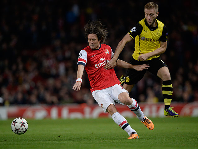 arsenal versus dortmund: Tomas Rosicky evades the challenge of Jakub Blaszczykowski