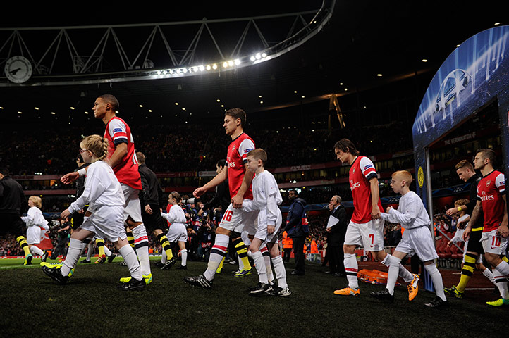 arsenal versus dortmund: The teams and mascots take to the pitch