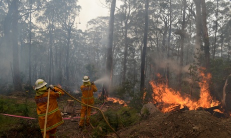 New South Wales Rural Fire Service crews protect a property on Bulgamatta Road in the township of Berambing in the Blue Mountains.