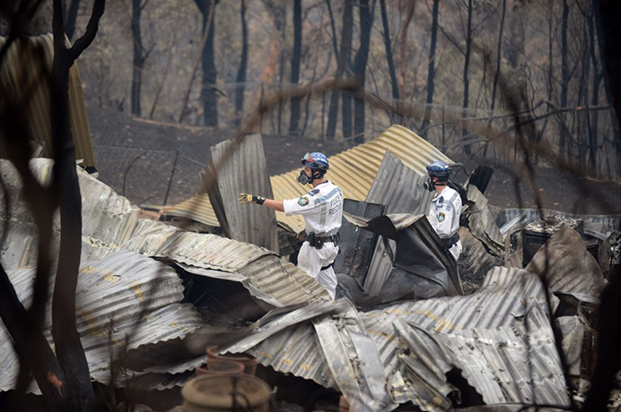 Bushfires Weds: Police Rescue Unit search through burnt down properties