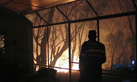 Roland Clarke, pictured inside his living room as bushfires rage outside in Mt Victoria last week.