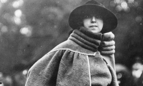 Woman wearing cape coat with bolster-like high collar, circa 1914