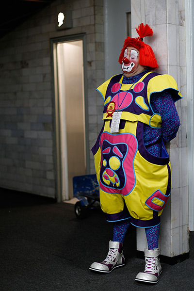 From the agencies: Clowns: A clown waits beside a restroom