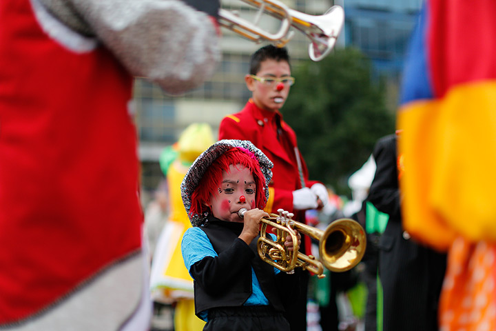 From the agencies: Clowns: A young clown blows on a trumpet 