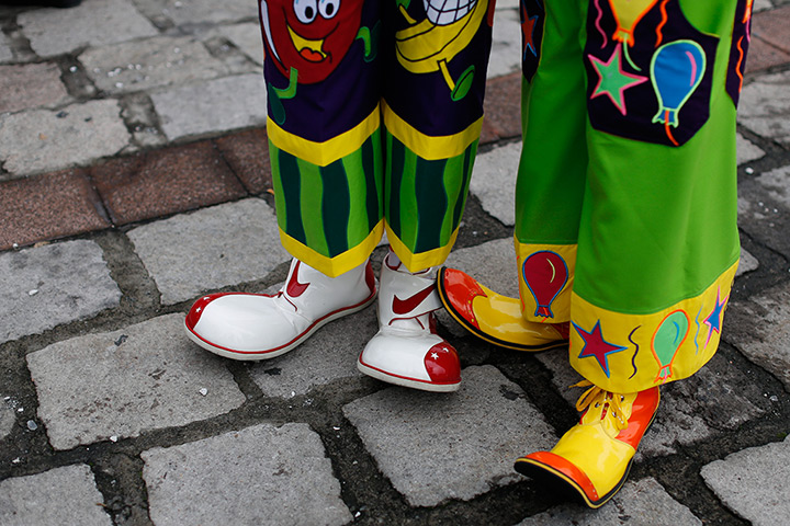 From the agencies: Clowns: Wearing oversized shoes, a pair of clowns wait to participate in a laugh-a-