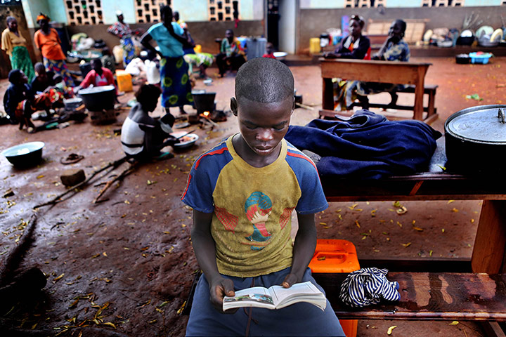 MSF in CAR: Boy reads book in camp