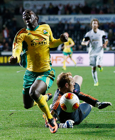 Wigan: Ibrahima Balde is fouled by Gerhard Tremmel