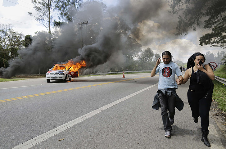 20 Photos: Demonstrators run from teargas near the Instituto Royal lab in Brazil