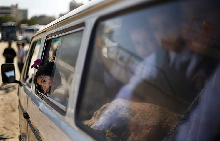 20 Photos: Palestinian schoolchildren after throwing flowers into the Seaport of Gaza