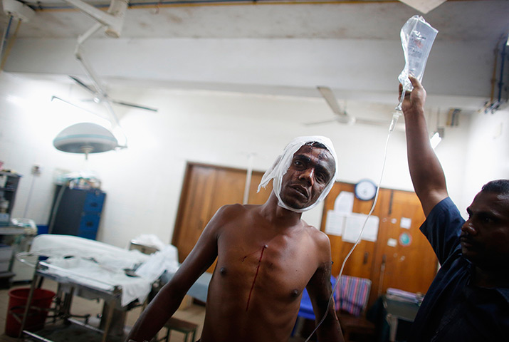 Weekend in pictures: Dhaka, Bangladesh: A colleague helps an autorickshaw driver to an operating theatre after he was injured in a crude bomb attack