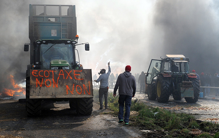 Weekend in pictures: Pont-de-Buis, France: Protesters block a motorway as they demonstrate against an ecotax that will come into effect on 1 January 2014