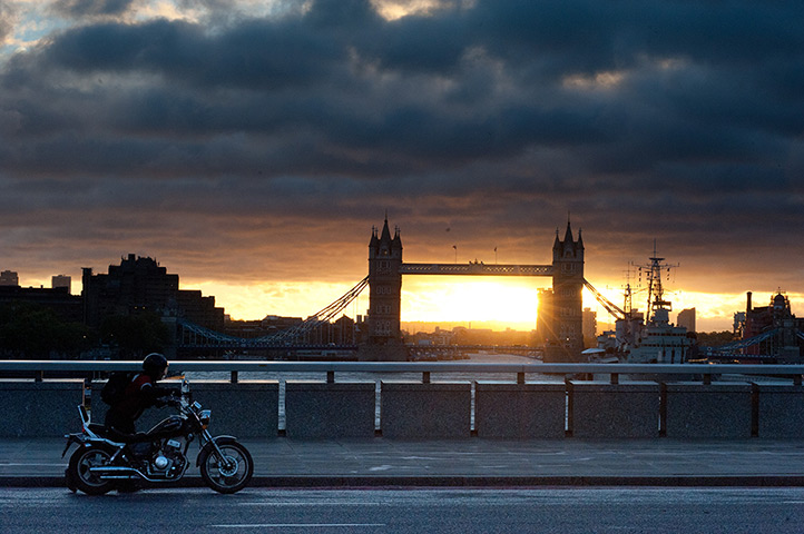 Storm damage: A man pushes his motorbike on London Bridge