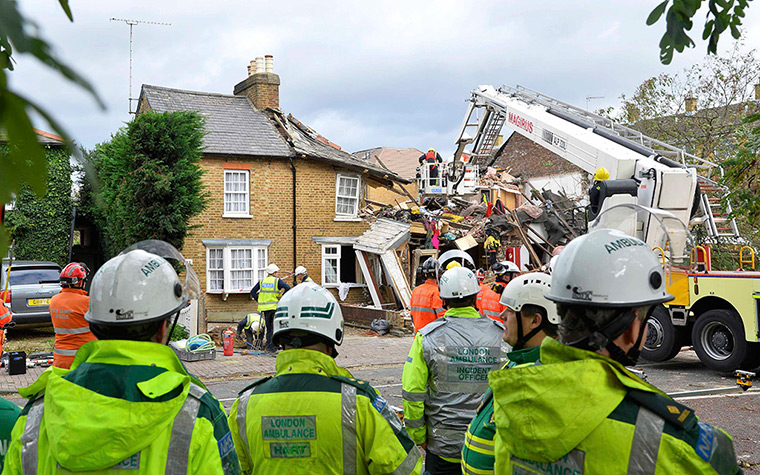 St Jude storm damage: Emergency services work at the scene of a gas explosion caused by a fallen tree in Hounslow, west London