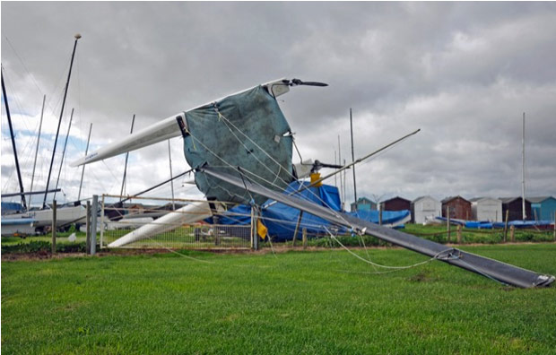 storm extra: Boats toppled by the wind lie piled up against a fence near Tendring in Ess