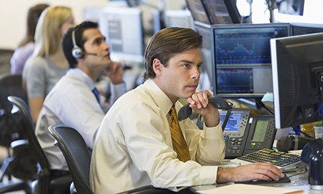 man at trading desk on stock market
