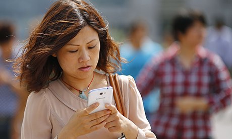 woman types on smartphone