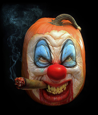 Pumpkin carving: A clown face carved out of a pumpkin