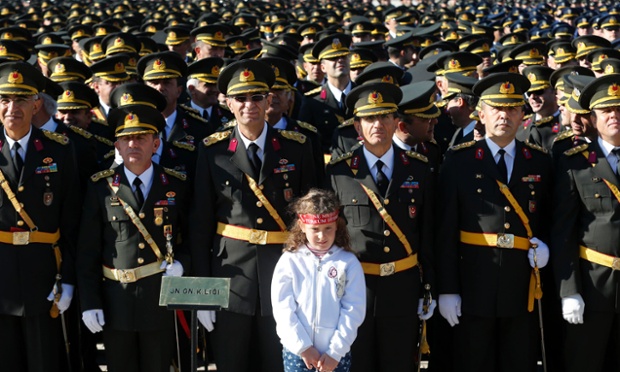 Zeynep Yektes, aged five, stands to attention with Turkish military officers during an official ceremony to mark the 90th anniversary of Republic Day at Anitkabir in Ankara. 