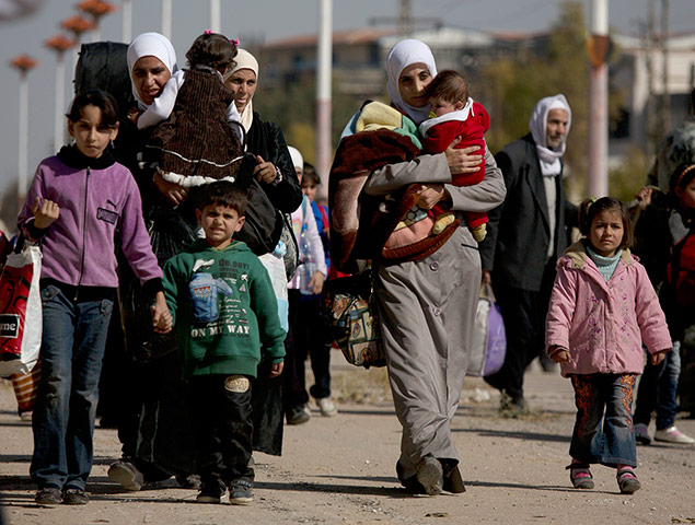 Syrian women carrying children