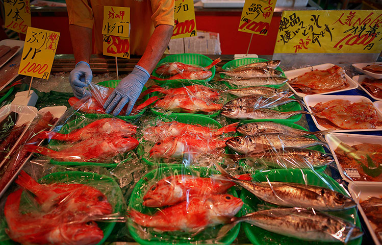Fukushima: A vendor offers fish for sale at a market in Iwaki town