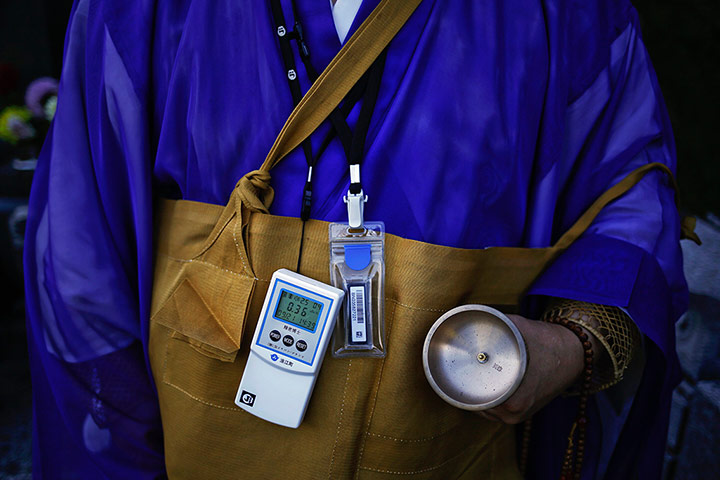 Fukushima: A Buddhist monk wears a Geiger counter 