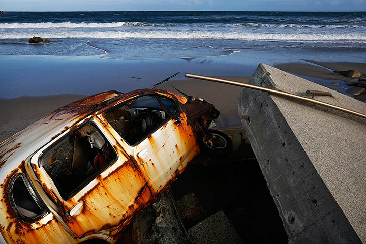 Fukushima: A beach is littered with tsunami barriers, wreckages of cars & other debris