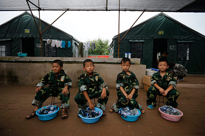 Boot Camp: Young children wait to do their laundry at a Summer Boot Camp in China
