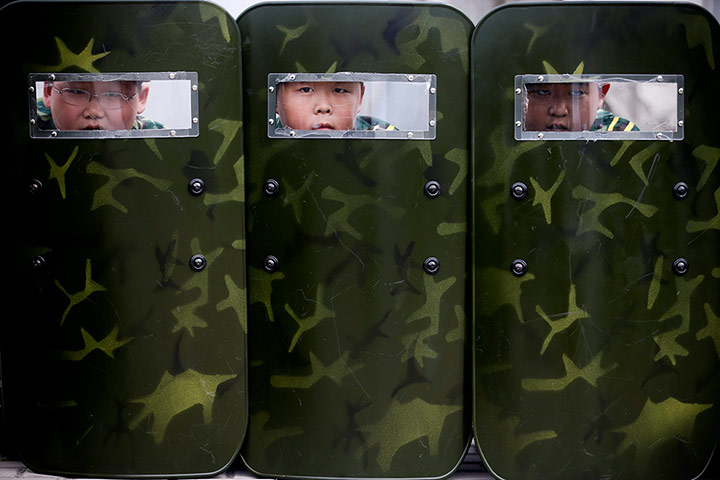 Boot Camp: Young children peer through sight windows of protective shields