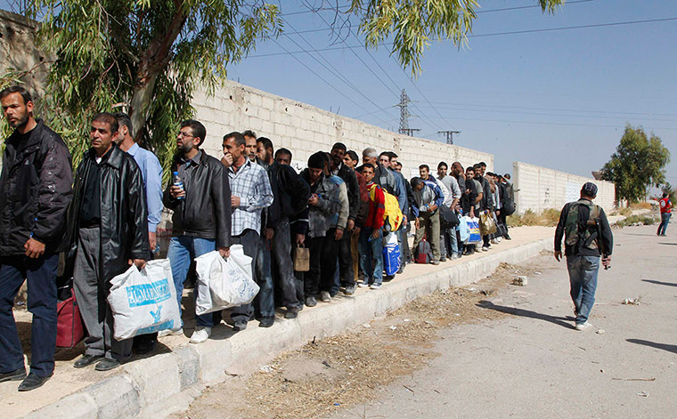 Men queueing to leave Moadamiya
