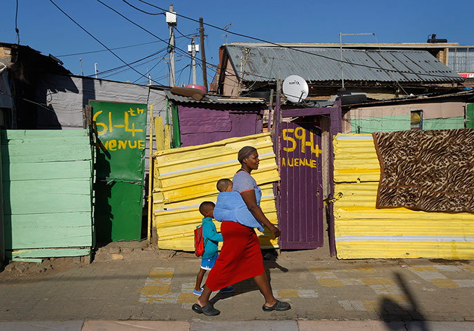 Alexandra Township: A mother walks her child to school