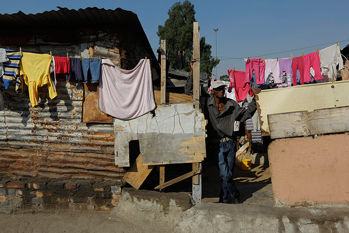 Alexandra Township: A man stands by a washing line