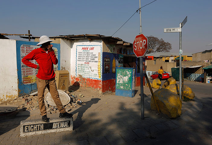 Alexandra Township: A man waits for a taxi