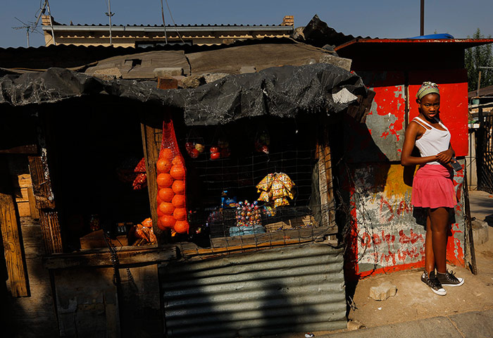 Alexandra Township: Girl stands by spaza shop