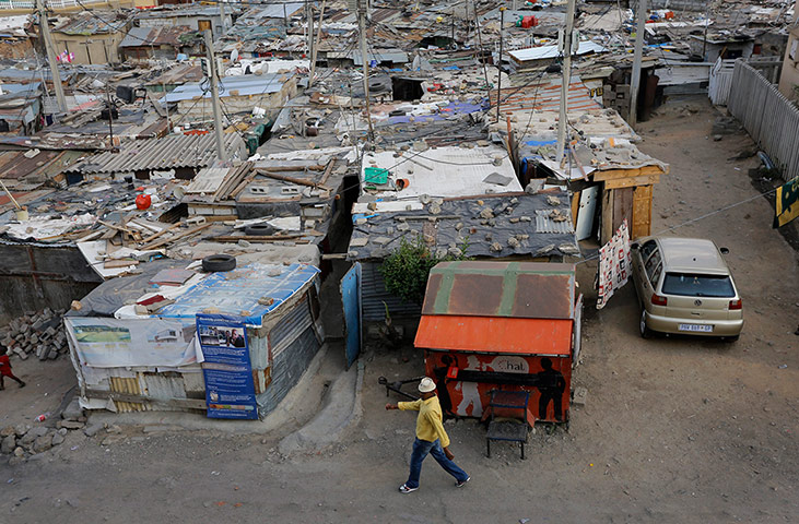 Alexandra Township: A man walks between shacks